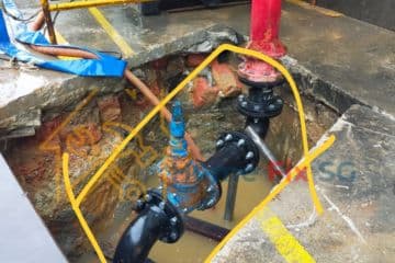 Professional repair of a heavy-duty underground water pipe system involving flange joints and valve replacement by Home Fix SG.