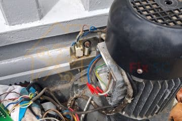 Internal view of an electric sliding gate motor with exposed wiring being serviced by Home Fix SG in Singapore.