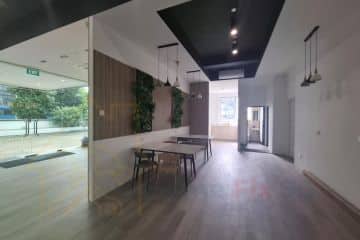 A modern commercial office interior featuring stylish pendant lighting, wooden wall panels, and premium flooring designed by Home Fix SG in Singapore.