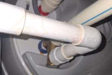 Detailed view of water heater plumbing pipe connections repaired by professional technicians at Home Fix SG.